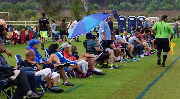 Parents cheering on the soccer sideline