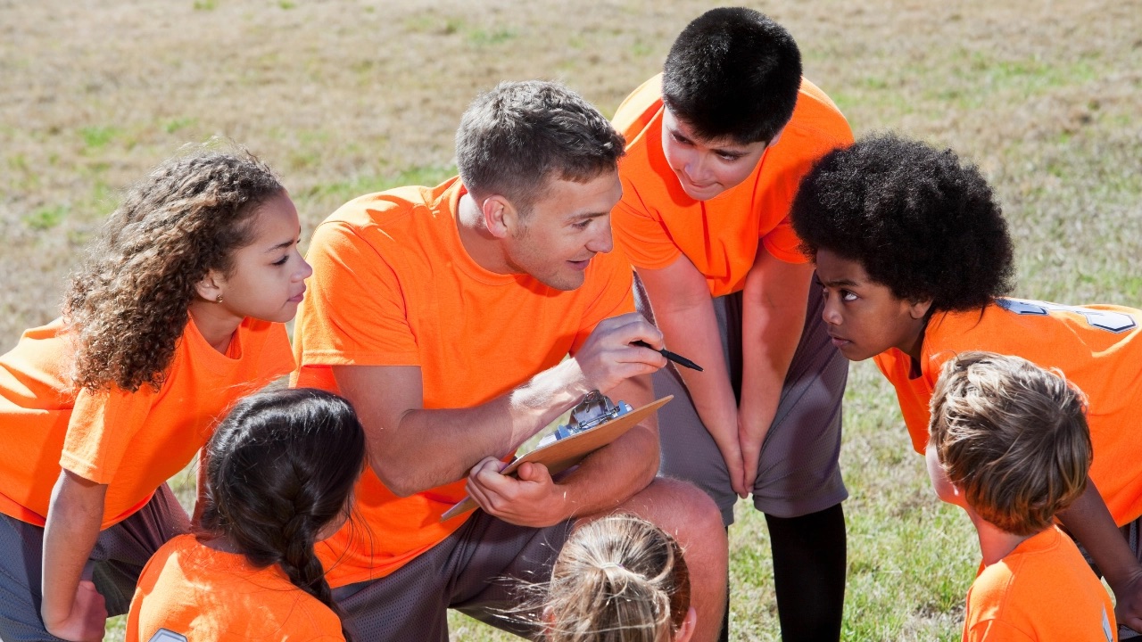 Coach with youth soccer players